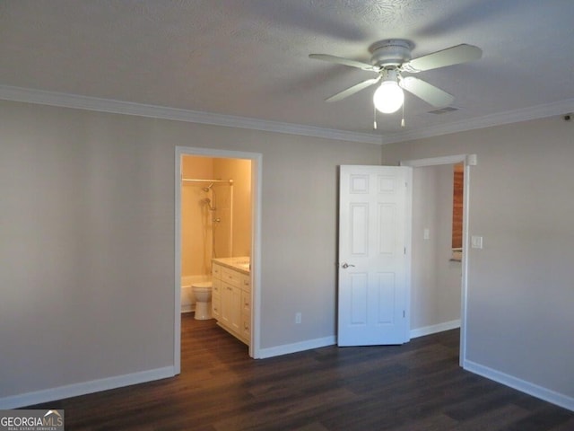 unfurnished bedroom with ceiling fan, ornamental molding, connected bathroom, and dark hardwood / wood-style flooring