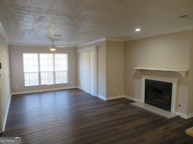 unfurnished living room featuring crown molding, ceiling fan, dark wood-type flooring, and a textured ceiling