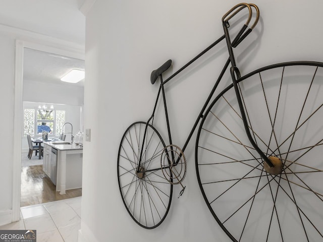 room details featuring sink, stainless steel dishwasher, and a chandelier