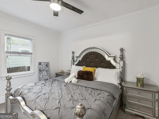 carpeted bedroom with crown molding and ceiling fan