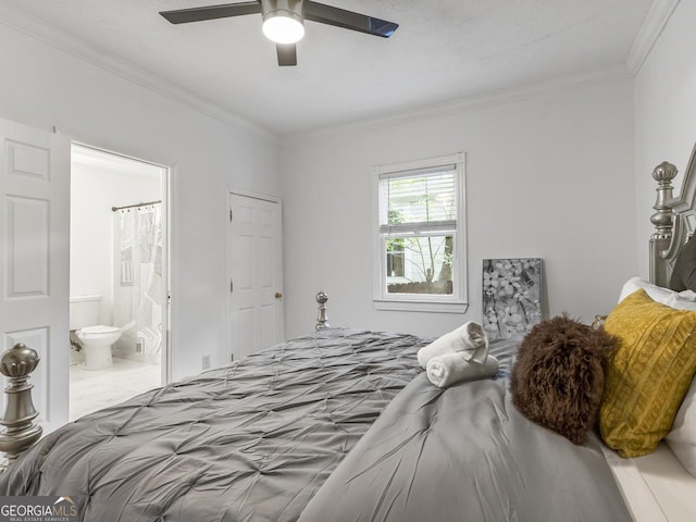 bedroom with ceiling fan, ensuite bath, and ornamental molding