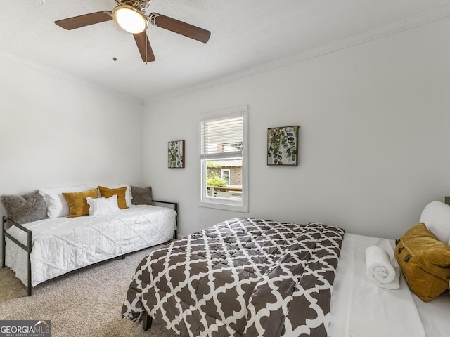 bedroom with crown molding, ceiling fan, and carpet