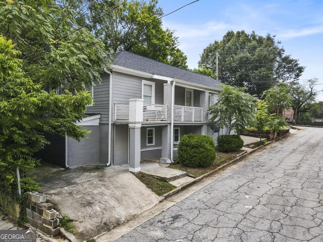 261 Fletcher St SW, Atlanta, GA 30315 - view of property with a balcony and roof with shingles