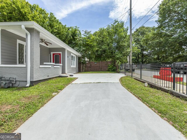 261 Fletcher St SW, Atlanta, GA 30315 - view of home's exterior featuring brick siding, concrete driveway, and a ceiling fan