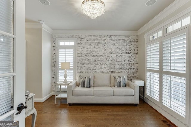 living room with an inviting chandelier, ornamental molding, and dark hardwood / wood-style floors