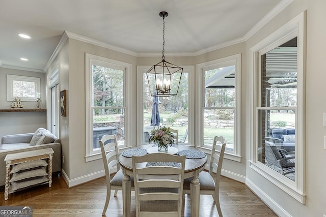 dining room featuring ornamental molding, a chandelier, and light hardwood / wood-style flooring