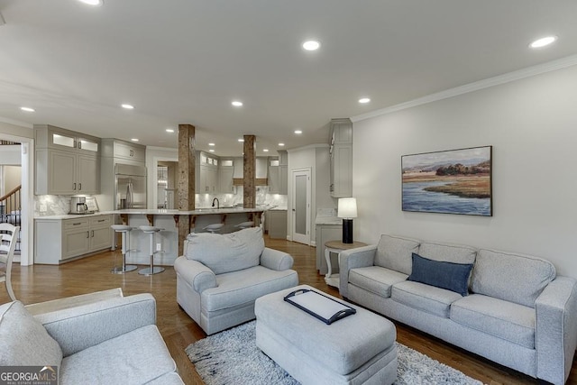 living room with crown molding and dark hardwood / wood-style floors