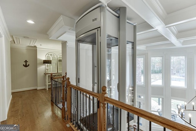 hallway featuring coffered ceiling, ornamental molding, beam ceiling, and hardwood / wood-style flooring