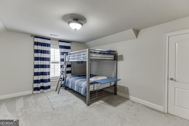 bedroom featuring vaulted ceiling and carpet flooring