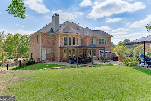 rear view of property with a lawn and a patio area