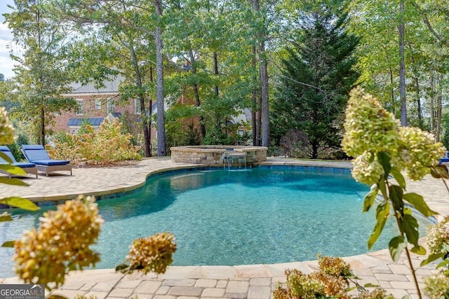 view of pool featuring an in ground hot tub and a patio area