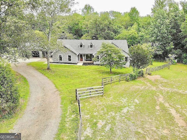 view of front facade with a front yard and a rural view