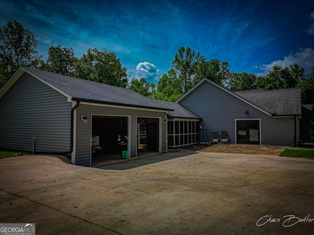 1150 Sutton Rd, Demorest, GA 30535 - view of side of home featuring a sunroom, a shingled roof, driveway, and an attached garage