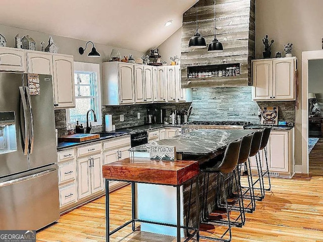 1150 Sutton Rd, Demorest, GA 30535 - kitchen with stainless steel fridge with ice dispenser, dark countertops, a sink, decorative backsplash, and vaulted ceiling