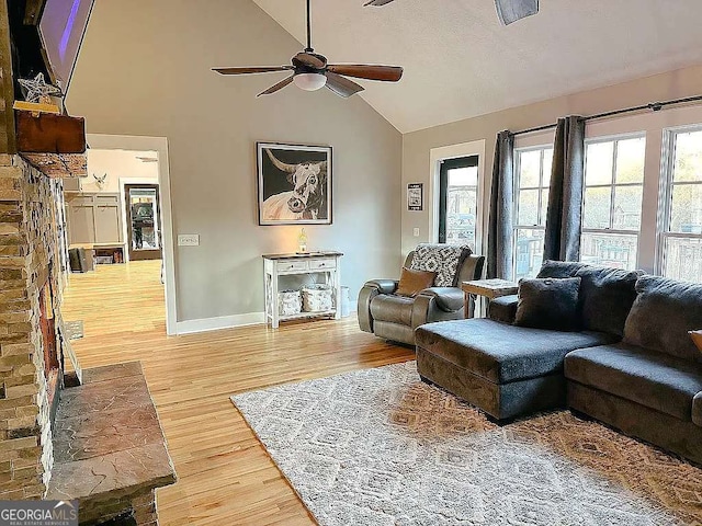 living room featuring vaulted ceiling, ceiling fan, and hardwood / wood-style floors