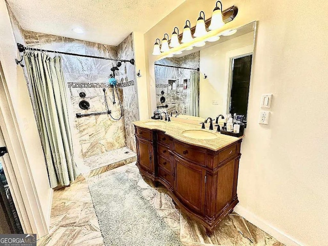 bathroom featuring vanity, a shower with shower curtain, and a textured ceiling