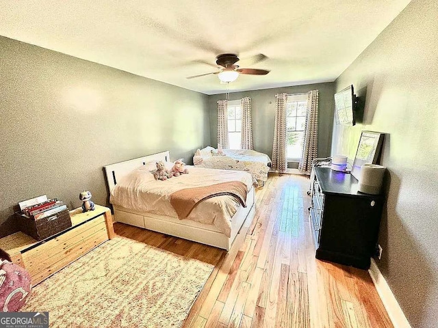 bedroom with hardwood / wood-style flooring and ceiling fan