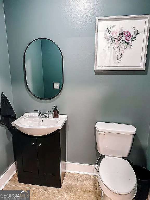 1150 Sutton Rd, Demorest, GA 30535 - half bath with vanity, toilet, baseboards, and tile patterned floors