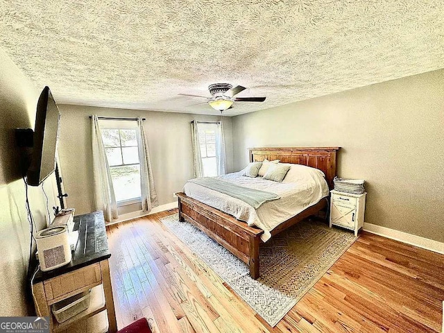 1150 Sutton Rd, Demorest, GA 30535 - bedroom with hardwood / wood-style flooring, baseboards, a ceiling fan, and a textured ceiling