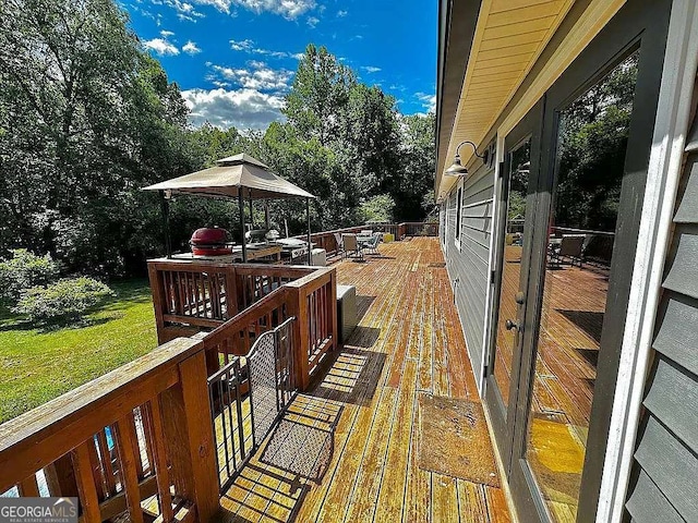 wooden terrace featuring a gazebo