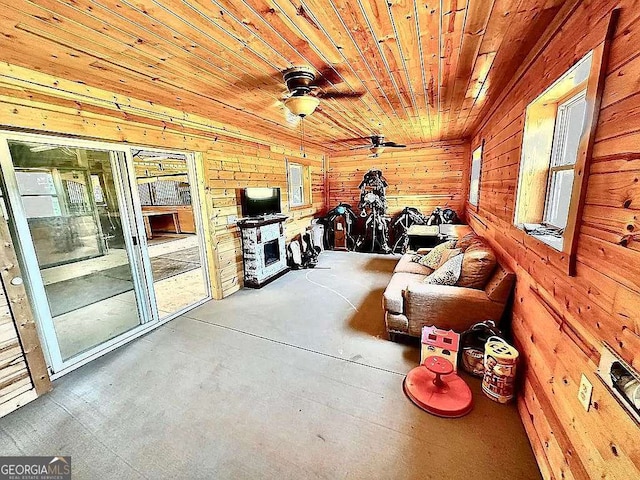 unfurnished sunroom with ceiling fan and wooden ceiling