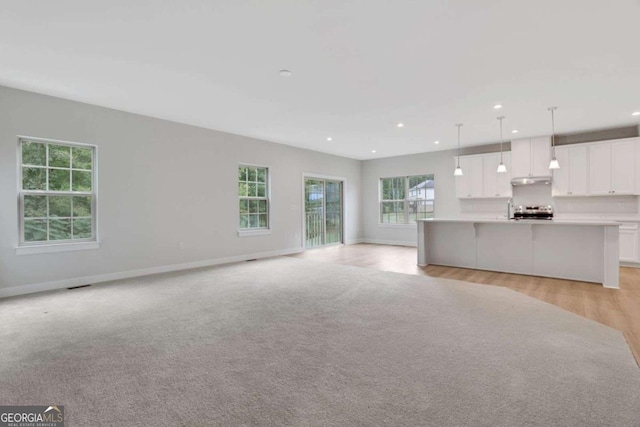 unfurnished living room with light hardwood / wood-style flooring