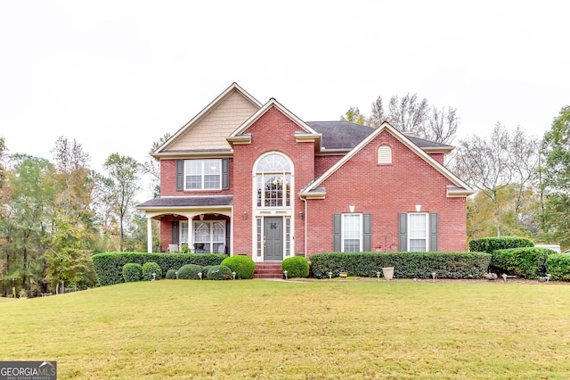 view of property featuring a front lawn