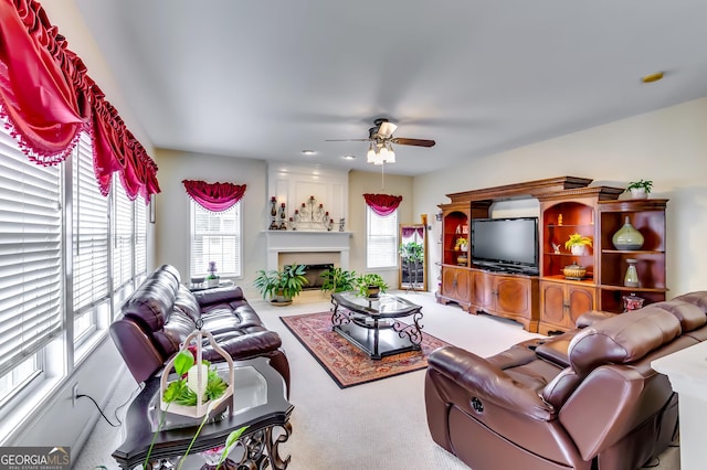 carpeted living room with ceiling fan