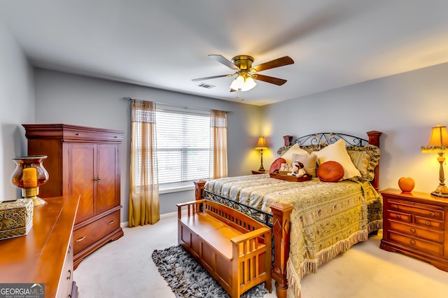 bedroom featuring light carpet and ceiling fan