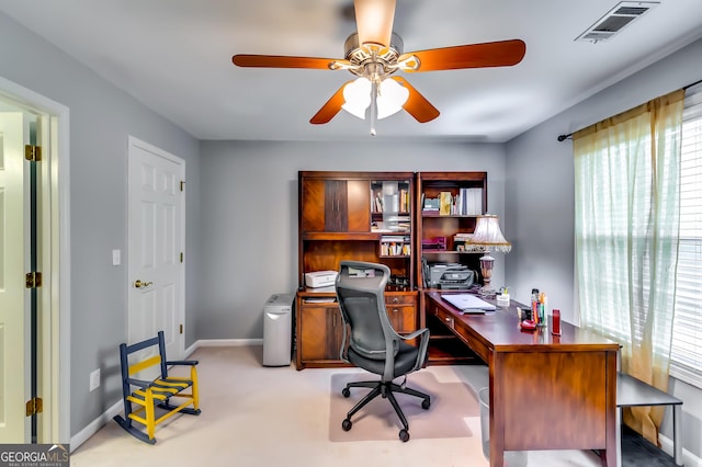 carpeted home office with ceiling fan