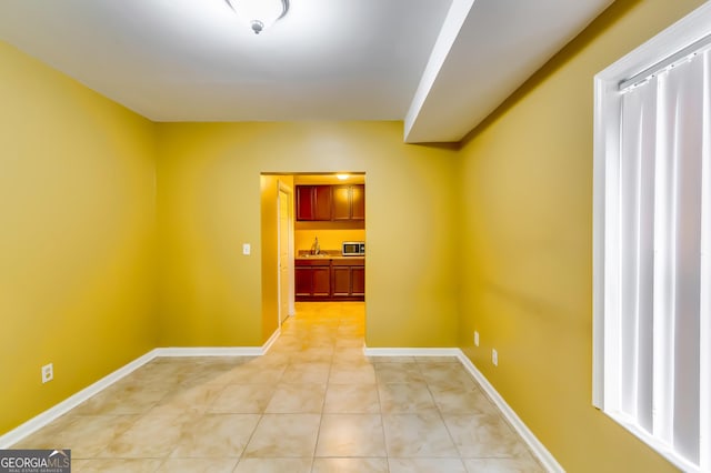 corridor featuring light tile patterned floors