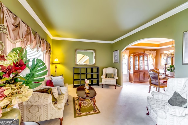 living area featuring ornamental molding, carpet flooring, and a chandelier