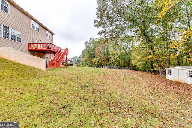 view of yard featuring a storage shed and a deck