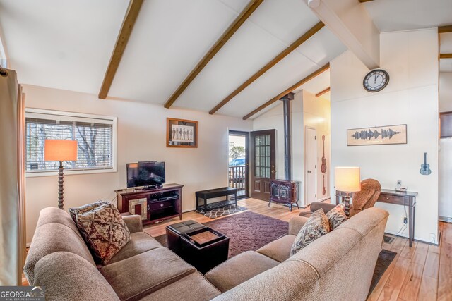 living room featuring wood-type flooring and lofted ceiling with beams