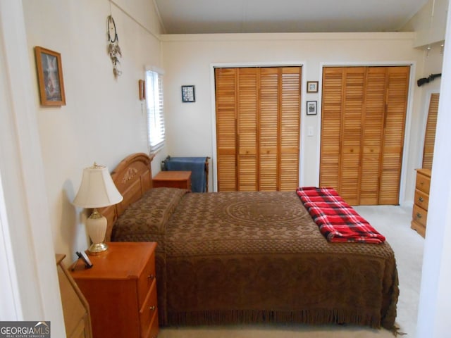 carpeted bedroom with multiple closets