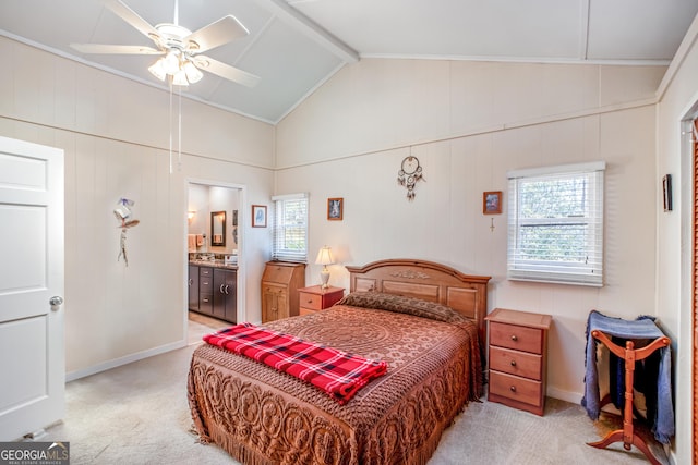 bedroom with ensuite bathroom, vaulted ceiling with beams, light colored carpet, and ceiling fan