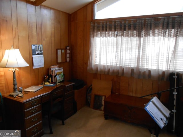 carpeted office with lofted ceiling and wood walls