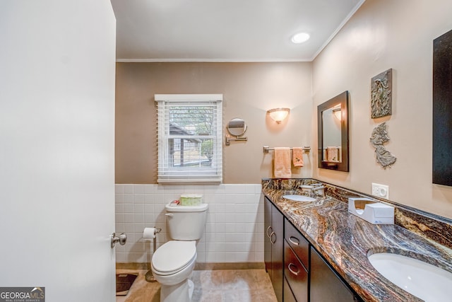 bathroom featuring crown molding, tile walls, vanity, tile patterned floors, and toilet