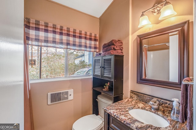 bathroom featuring vanity, toilet, and walk in shower