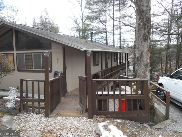 view of snow covered exterior featuring a deck