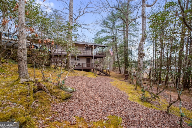 rear view of property featuring a wooden deck