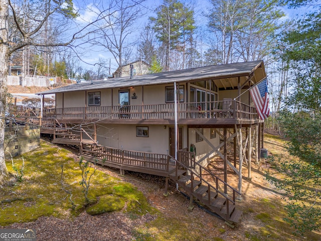 rear view of house with a wooden deck