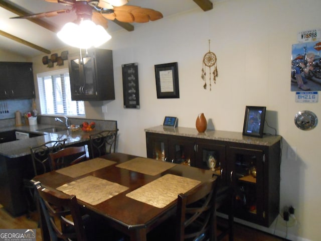 dining space featuring ceiling fan and sink