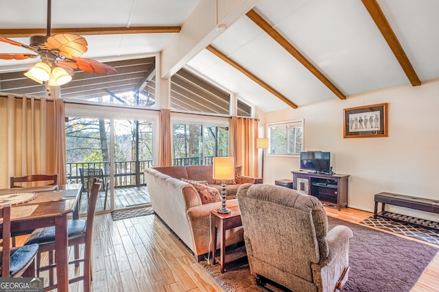 living room with lofted ceiling with beams, plenty of natural light, and hardwood / wood-style floors