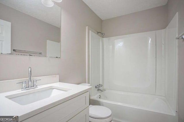 full bathroom featuring vanity, toilet, a textured ceiling, and shower / bath combination