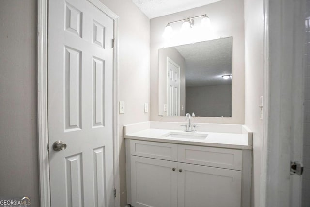 bathroom featuring vanity and a textured ceiling