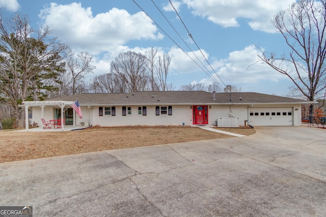 single story home with a garage, a pergola, a patio area, and a front yard