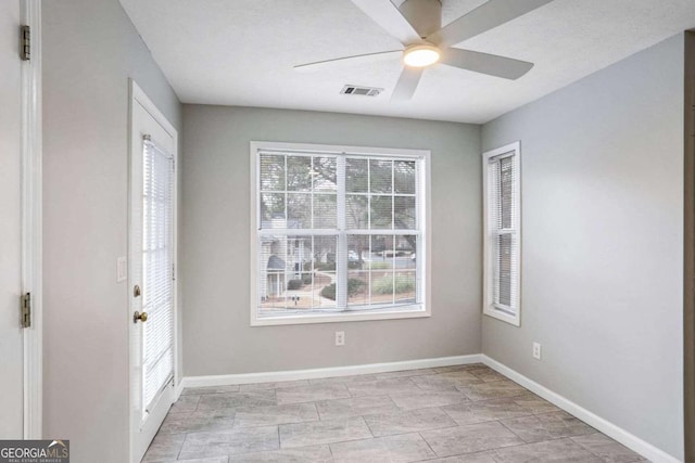 foyer entrance with ceiling fan