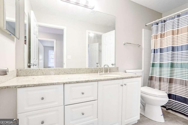 bathroom featuring vanity, curtained shower, and toilet