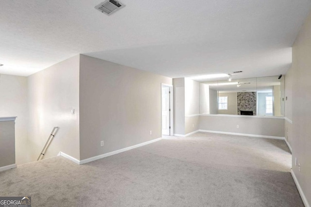 carpeted spare room with a textured ceiling